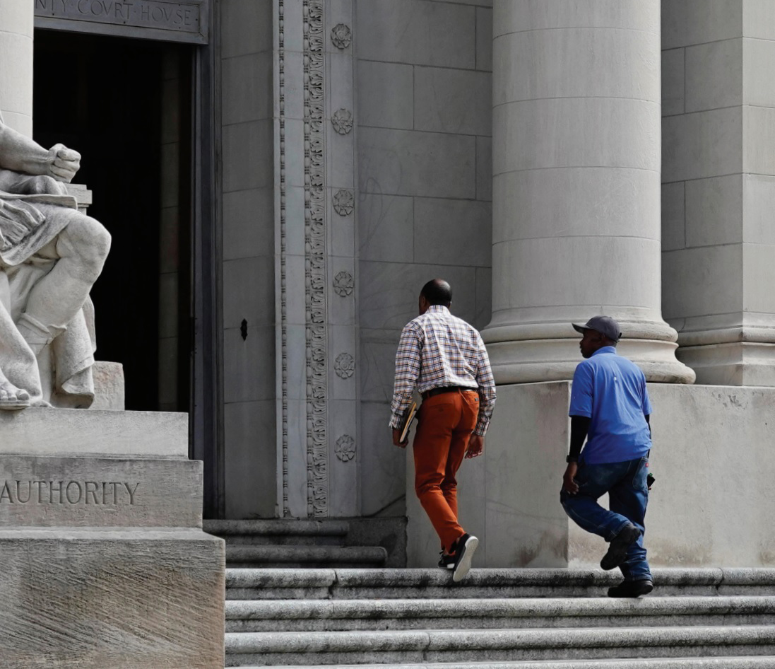 Two men walking up stairs into court house