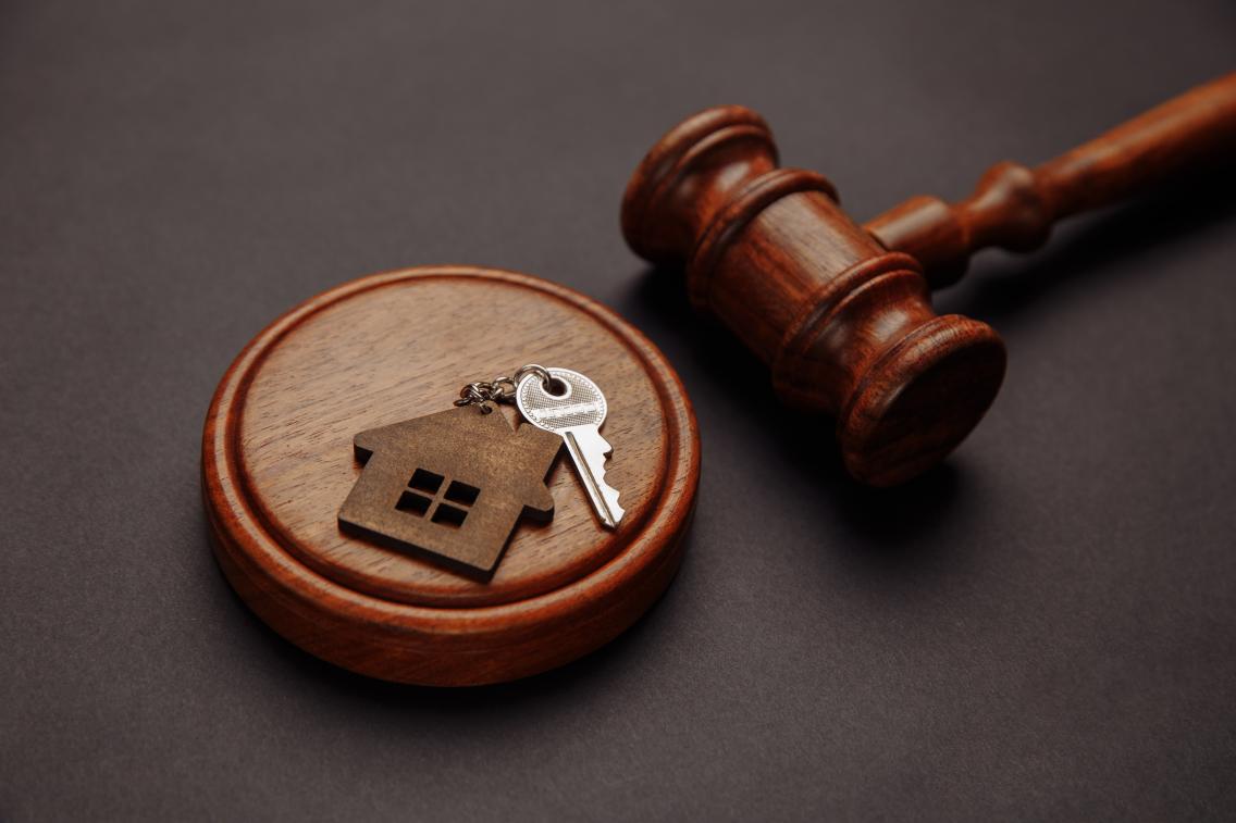 gavel and keys with house shaped keychain