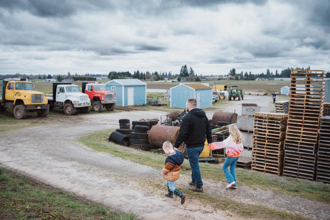 family walking through ranch with tractors